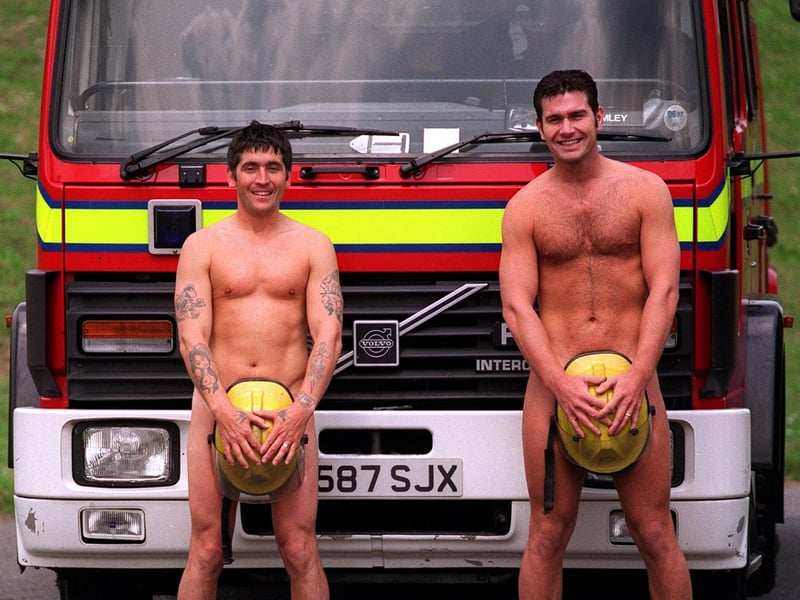 Firefighters Gino Webster (left) and Rob Hart, stripped off to show what you could buy at the slave auction held at the Bramley Fire Station's open day in June 1997.