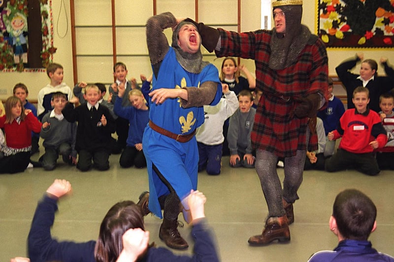 Pupils from Bramley Primary watch as actors from the English Shakespeare Company perform a scene from Macbeth. Pictured are actors Charlie Woods as Macduff and Mike Rogers as Macbeth.