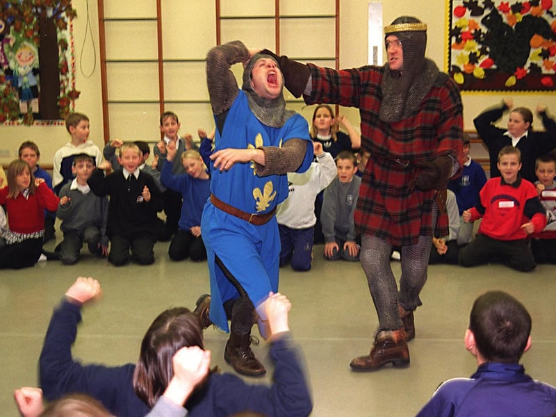 Pupils from Bramley Primary watch as actors from the English Shakespeare Company perform a scene from Macbeth. Pictured are actors Charlie Woods as Macduff and Mike Rogers as Macbeth.