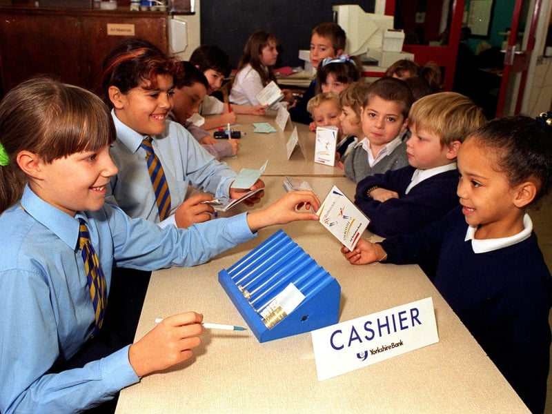 Laura Woodhead carries out a transaction for Jordaine Kirk as pupils at Sandford Primary as part of a Yorkshire Bank initiative.