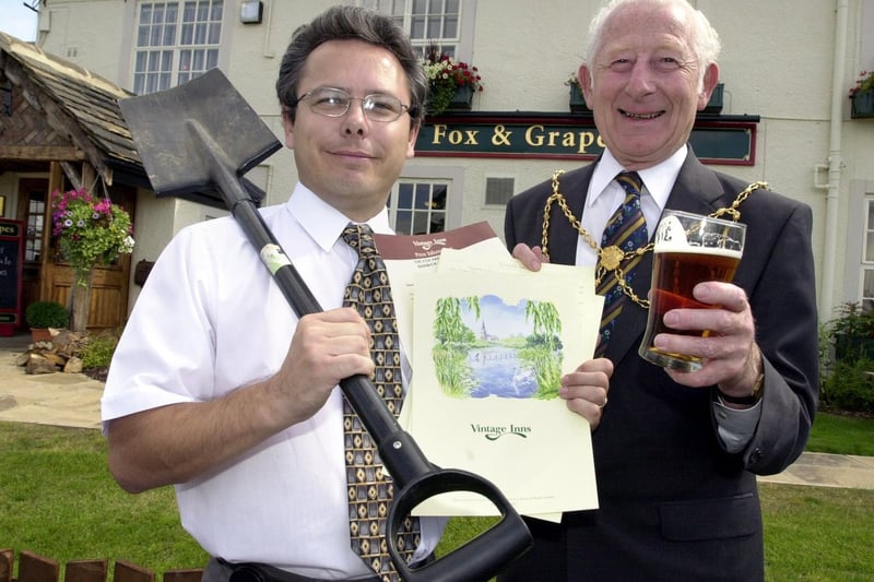 Malcolm Richardson, landlord at the newly refurbished Fox and Grapes at Barwick-in-Elmet, is pictured with deputy Lord Mayor of Leeds Frank Robinson with items for a time capsule to be buried at the pub.