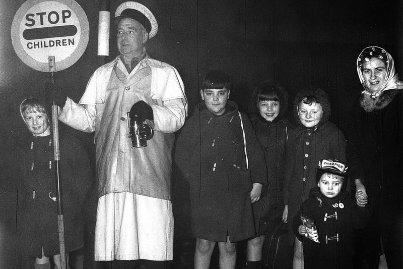 Dense fog on a  mid-January morning couldn't deter pupils turning up for lessons at Woodfield Primary School in 1969, with Mr Morris the crossing patrol man using his red-light  lantern for safety.