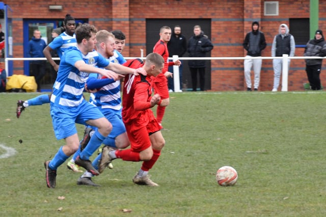 Glasshoughton Welfare players team up to win the ball in midfield.  Picture: Rob Hare