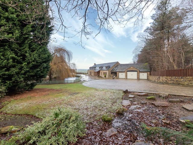 There's a large pond, mature trees and shrubs, and decked and paved areas within the lawned gardens.