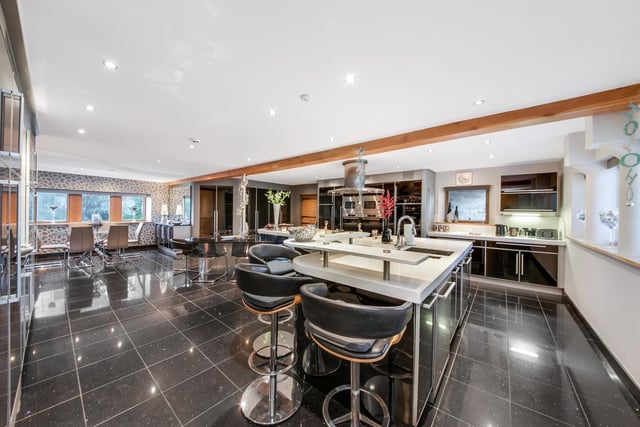 The glossy fitted kitchen with dining and family areas.