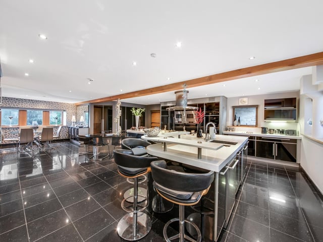 The glossy fitted kitchen with dining and family areas.