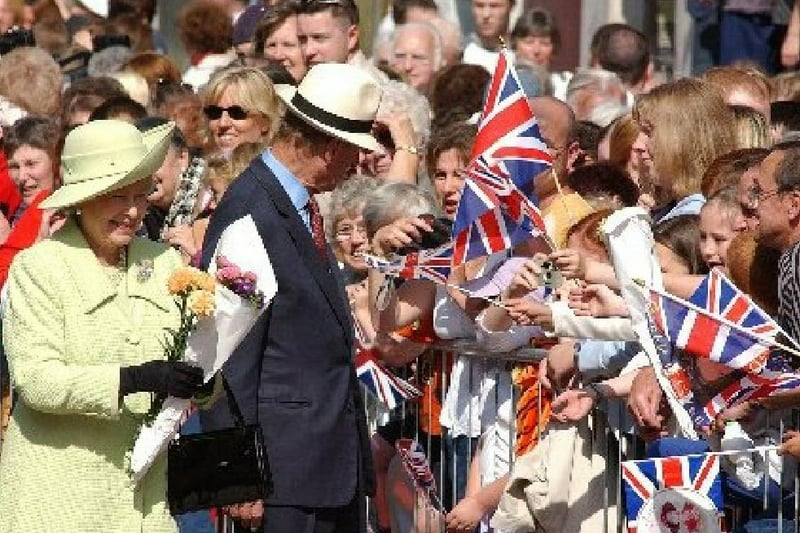 The Queen and Prince Philip meet the crowds during their visit to Preston in 2002