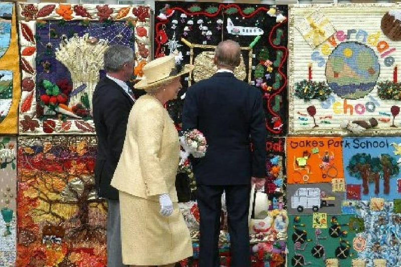 The Queen and Duke of Edinburgh looking at the first nineteen squares of the new Golden Tapestry that have been completed. moor park junior school blackpool have contributed to the tapestry