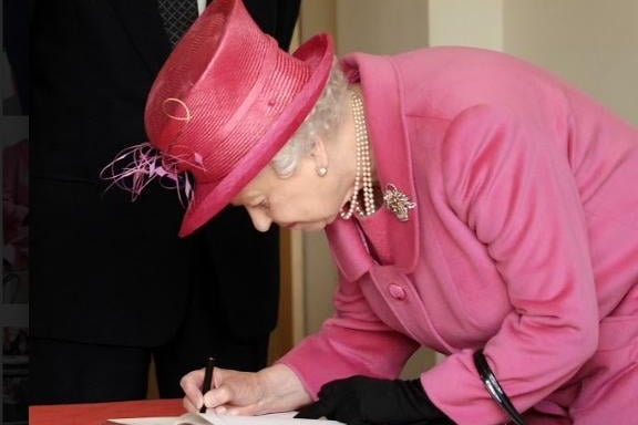 The Queen signs a commemorative book at Heinz