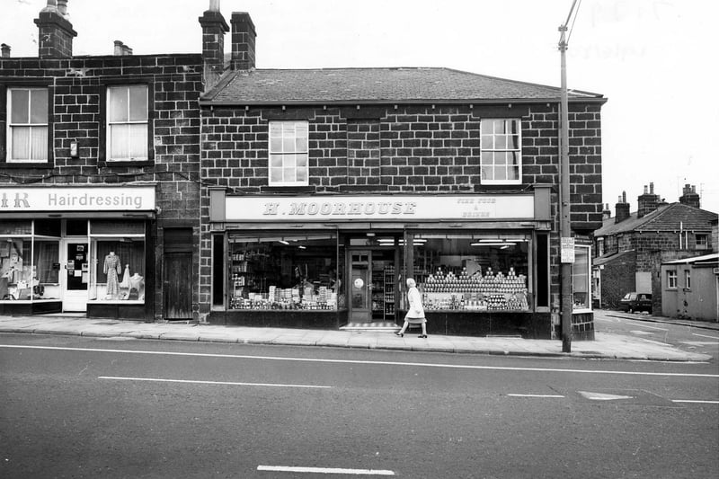 Otley Road in June 1980 with the junction with Cottage Road on the right. Pictured is H. Moorhouse, grocers, and Mayfair Fashions and Hairdressing.