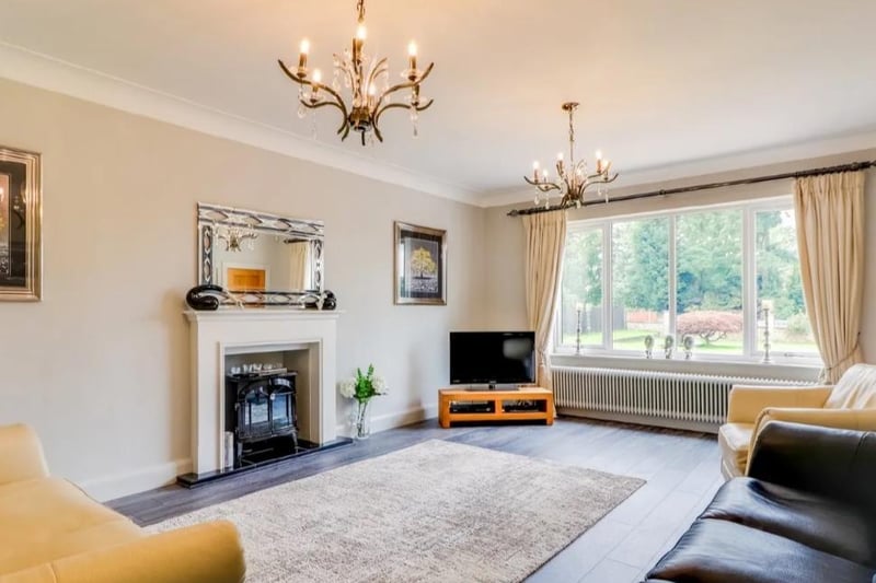 L A grandly proportioned room with a large window to the front, old school style radiator, contemporary style laminate flooring and a feature fireplace with a tiled hearth (not currently in use).