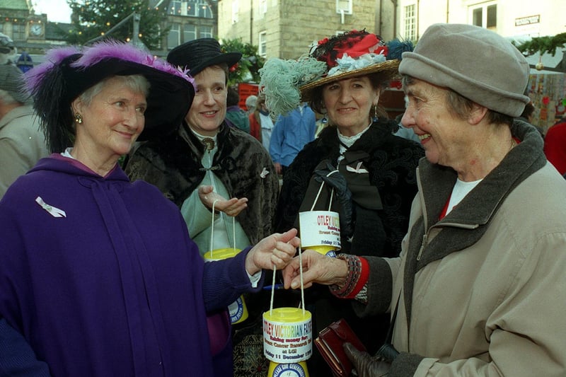 Dressed in their finery, from left, Tina Dawson and Julie Cook of the Otley Victorian Fayre Committee, with Katie Simpson of chosen charity Breast Cancer Research . They receive a donation from shopper Pamela Jowett.