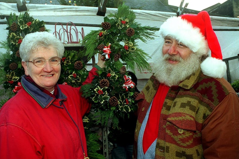 Christine Watson gets a helping hand from a Father Christmas stall holder as she chooses her decorations at Otley Victorian Fayre in December 1998.