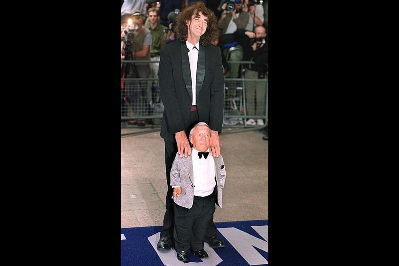 Actor Peter Mayhew (top), who played Chewbaca the Wookey in the first three films poses with Kenny Baker who plays R2D2 in both the older films as well as the new film "Episode 1 The Phantom Menace" as they arrive for the premier at London's Leicester square 14 July 1999