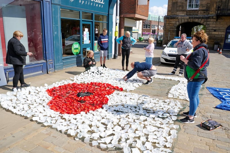 The display of bottle base poppies, made by the community was attached to netting and adorned the face of Pontefract Town Hall