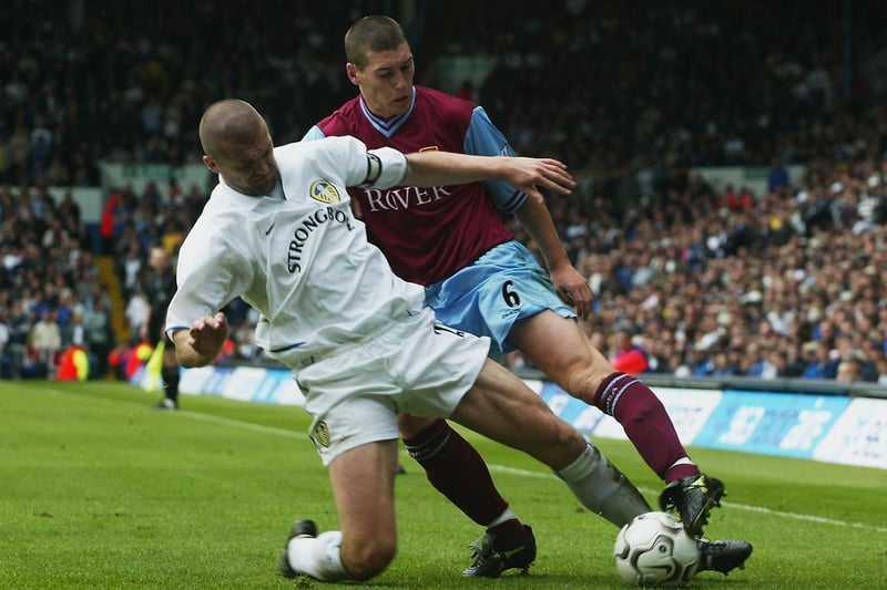 Aston Villa's Gareth Barry is prevented from crossing the ball by Dominic Matteo.