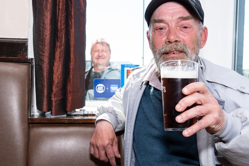 Robert Clarke raises a pint in celebration of pubs re-opening this week, with a great 'photobomb' too!
