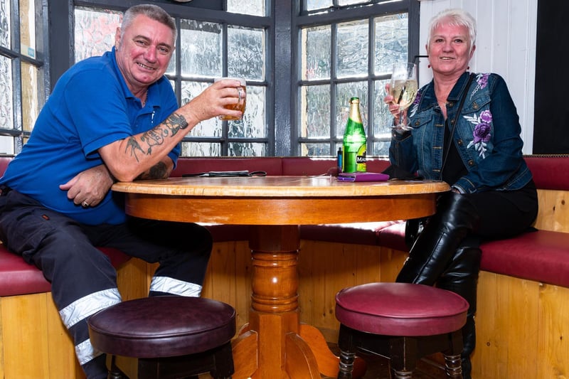Dave Hargreaves and Janet Johnson enjoy a pint in the window at The Masons.