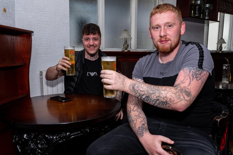 Brandon Stone and Andrew Smith raise their glasses at The Joiners.