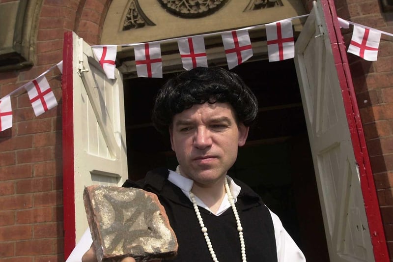Bryan Sitch from Leeds Museums and Galleries looks at a medieval tile dressed as a monk as part of a special event to mark St Georges Day at Cross Gates Methodist Church.