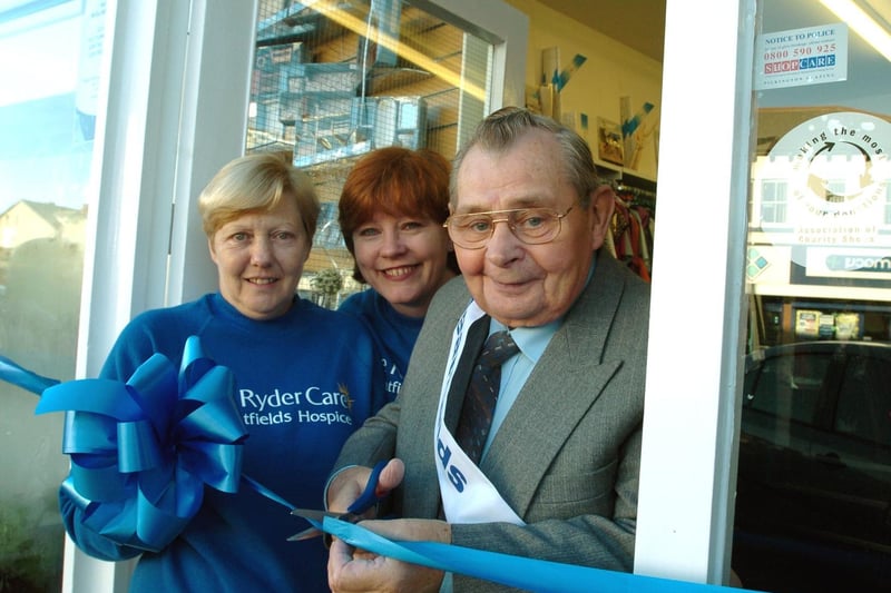 John Andrews cuts the ribbon to open the new Sue Ryder Care store on Austhorpe Road in November 2004. He is watched by joint managers Ann-Marie Brook (centre) and Christine Cockrem.