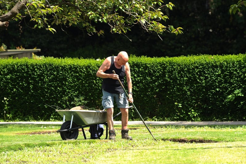A gardener gets to work in the heat of the sun at Pudsey Park.
