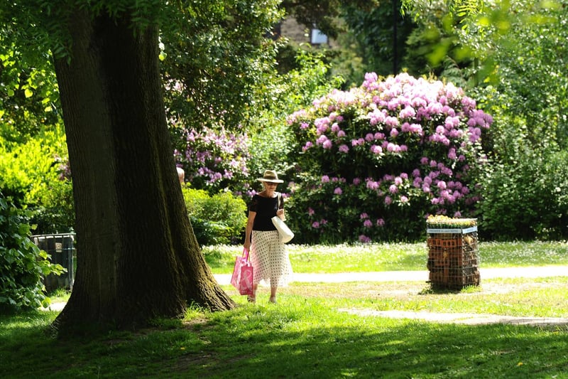 A woman walks through Pudsey Park as Leeds jumps into June with a heatwave.