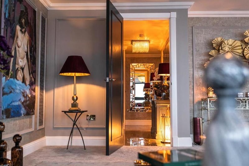 Guests and owners enter the penthouse through the front door which leads into a small corridor with another door to the living room and kitchen.