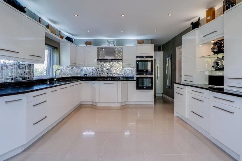 A glossy kitchen with fitted units and appliances