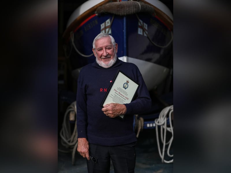 Former coxswain and museum curator, Pete Thomson MBE, with his certificate of thanks from the RNLI.