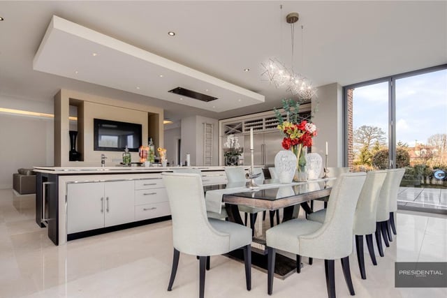 The bespoke kitchen by Intervari has a range of Wolf appliances and a central island unit. The dining area has bifold doors out onto the rear garden terrace ,perfect for al fresco dining. To the rear of the kitchen there is a separate family/tv room
