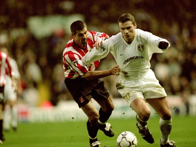 Mark Viduka holds off Sunderland's Emerson Thome.