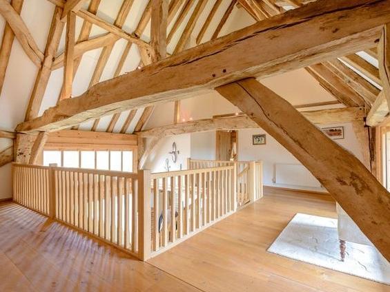 Outside there is an extensive gravelled parking area, large timber framed double car barn, garage and store room.