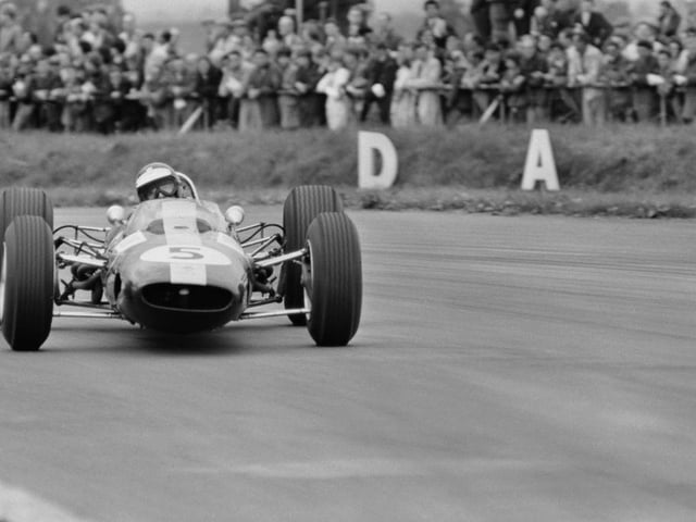 The legendary Jim Clark goes sideways in his Lotus 33 during the 1965 race at Silverstone one of the Scot's six wins that year on his way to the world title.