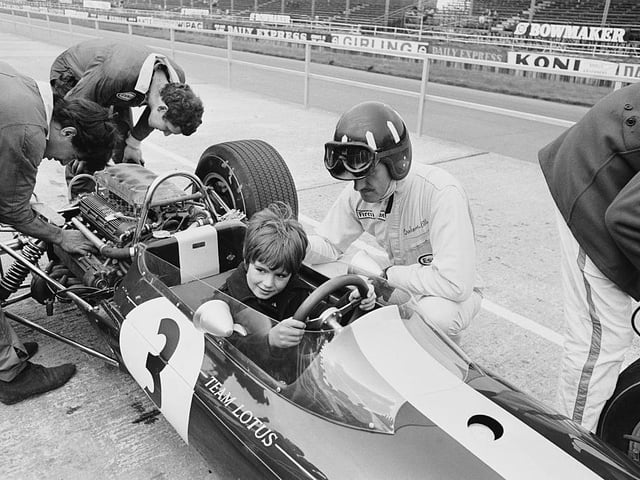 Graham Hill lets son, future world F1 champion Damon, try out his Lotus before the 1967 GP at Silverstone. Hill retired from a race won by Scottish legend Jim Clark, who was tragically killed at Hockenheim nine months later