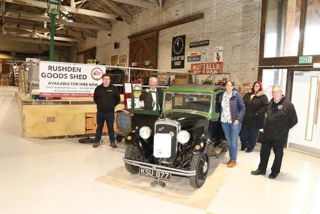One of the old vehicles on show inside Rushden Goods Shed with members of Rushden Historical Transport Society