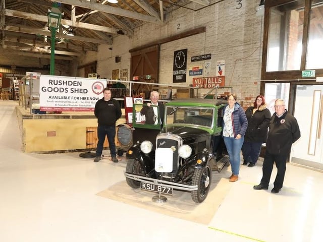 One of the old vehicles on show inside Rushden Goods Shed with members of Rushden Historical Transport Society