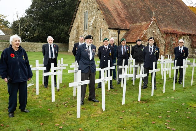 Some of the ex-service men and women who came to St Peter's Church, Selsey, war memorial for a minute's silence on Remembrance Sunday. The 48 wooden crosses have the names of local service men who fell in WWII. Photo: Chris Hatton SUS-200911-180809001