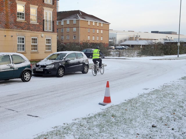 A cyclist braves the un-cleared Henry Bird Way