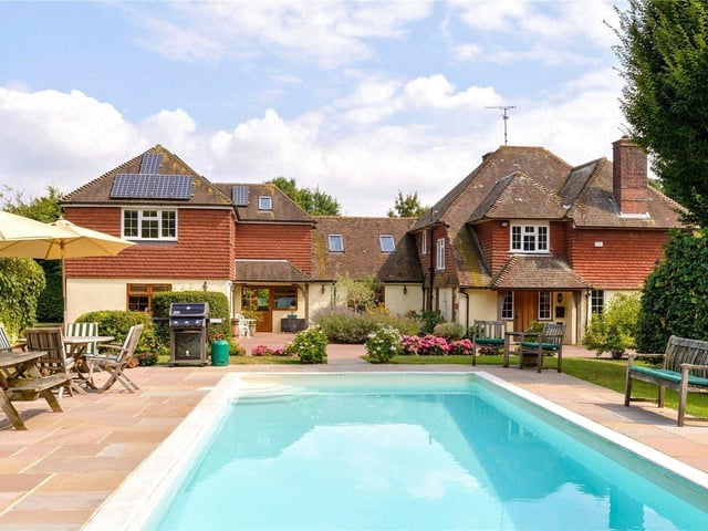 A spacious detached family home of character set in approximately 3.4 acres of well-established gardens and grounds, situated at the foot of the South Downs. Price: £1,750,000.