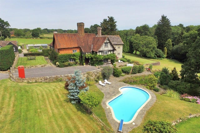 Grade II listed 15th century manor house with landscaped gardens, paddock, lake, tennis court with pavilion and a nine-hole practise golf course. Price: £3,650,000.