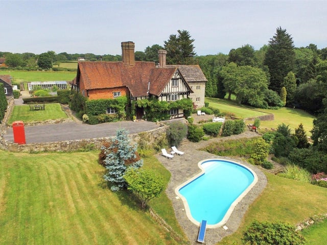 Grade II listed 15th century manor house with landscaped gardens, paddock, lake, tennis court with pavilion and a nine-hole practise golf course. Price: £3,650,000.