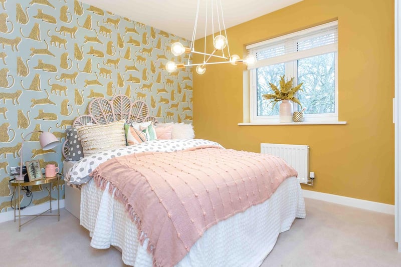 Bedroom 3:
The room has so many elements of fun – from the leopard wallpaper and peacock-winged headboard, right through to the low-hanging light fixture and bright pop of mustard yellow.

With so many bright colours and patterns in the space,  some gentle pink accents  have been introduced to break up the colours and create a soft, feminine atmosphere.