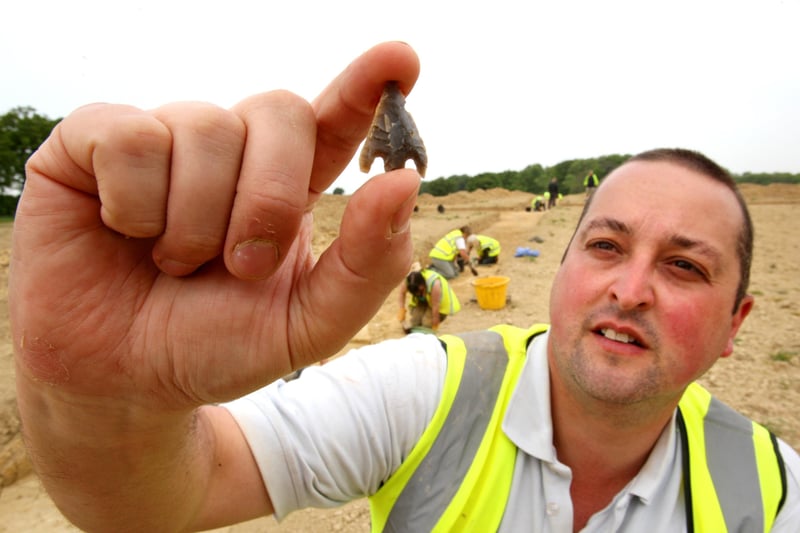 HOR 050511 Archaeological excavation at Chichester College, Brinsbury Campus. Ian Robinson with an arrowhead. photo by derek martin ENGSNL00120110605114610