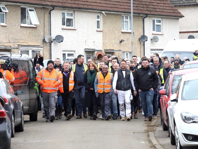 Volunteers walk down to the house to meet the family