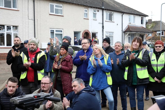 About 100 tradespeople and volunteers joined to clap the family