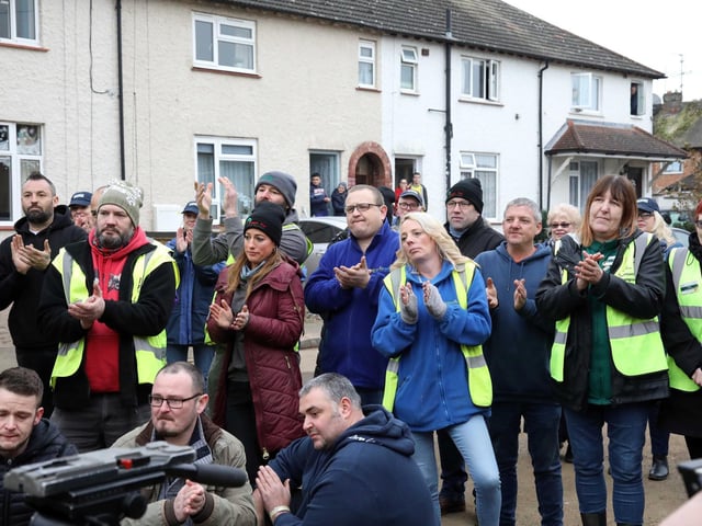 About 100 tradespeople and volunteers joined to clap the family