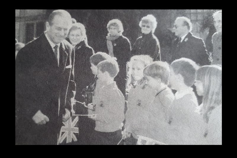 Prince Philip shares a joke with youngsters from Coten End Primary School at the Lord Leycester Hospital during a visit in 1996.