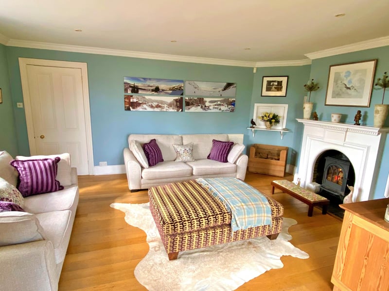 The sitting room with wood burner and French doors leading to the gardens