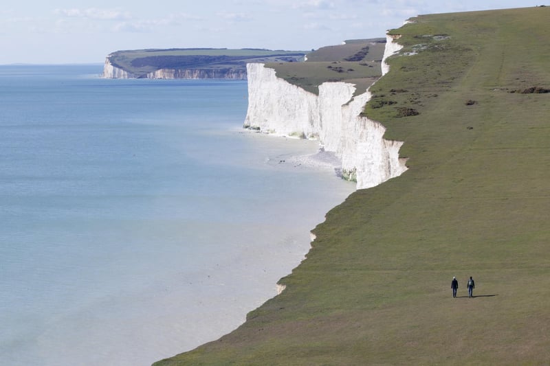 Walkers at Beachy Head, by Martin Rumary. SUS-210505-111032001